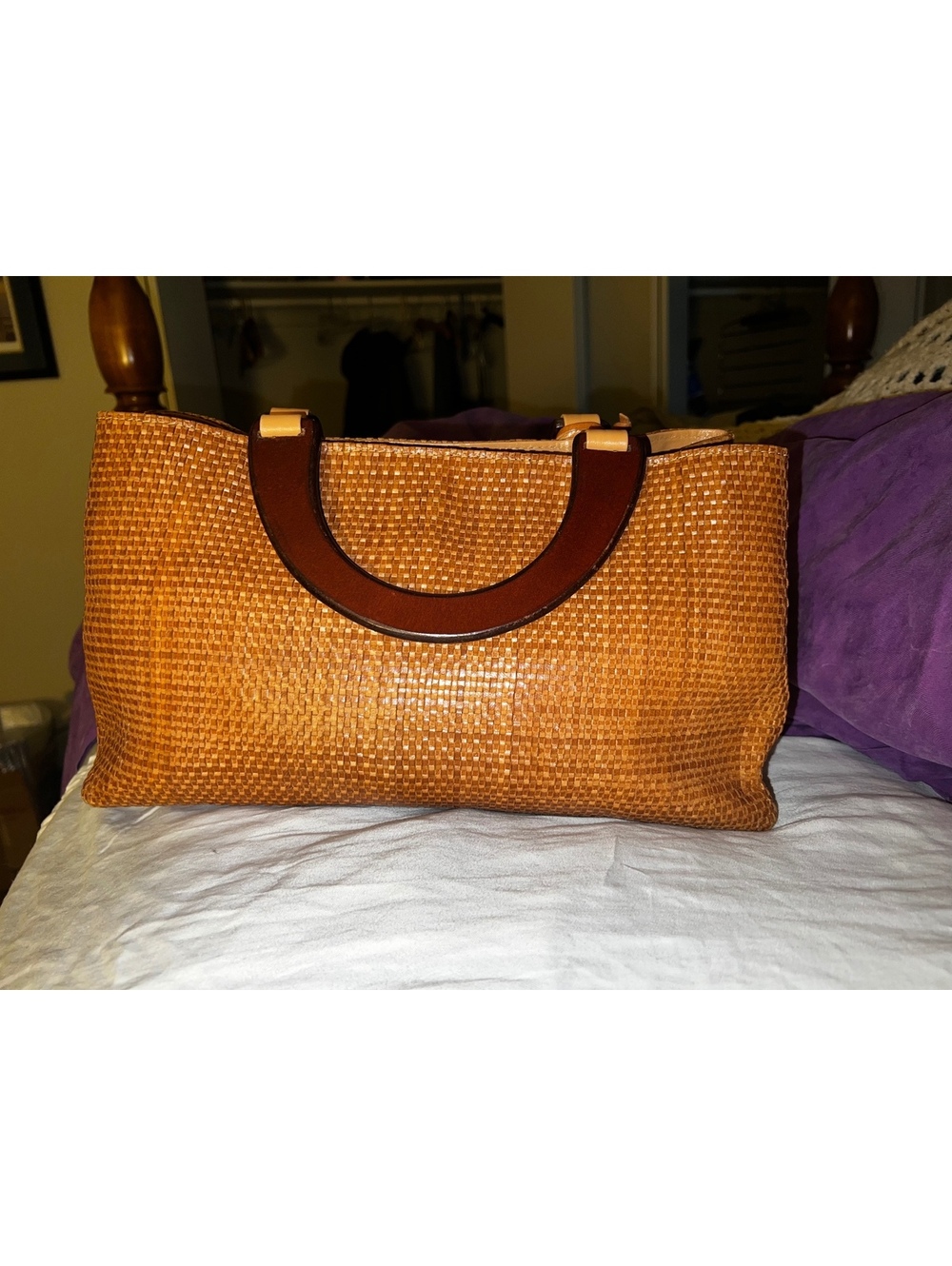 Tan woven handbag with wooden handles